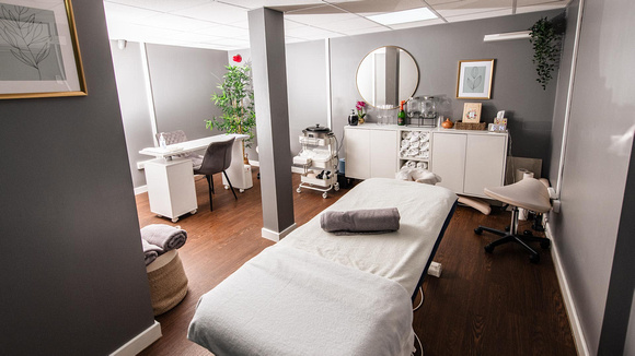 A spa room with a massage table in the middle 