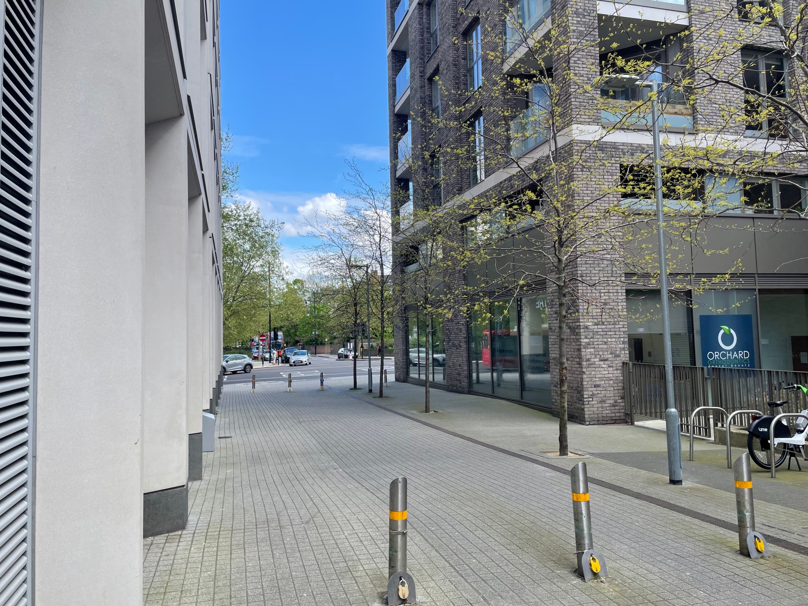 Street view of Porden Street with modern buildings and trees on the right of the image.