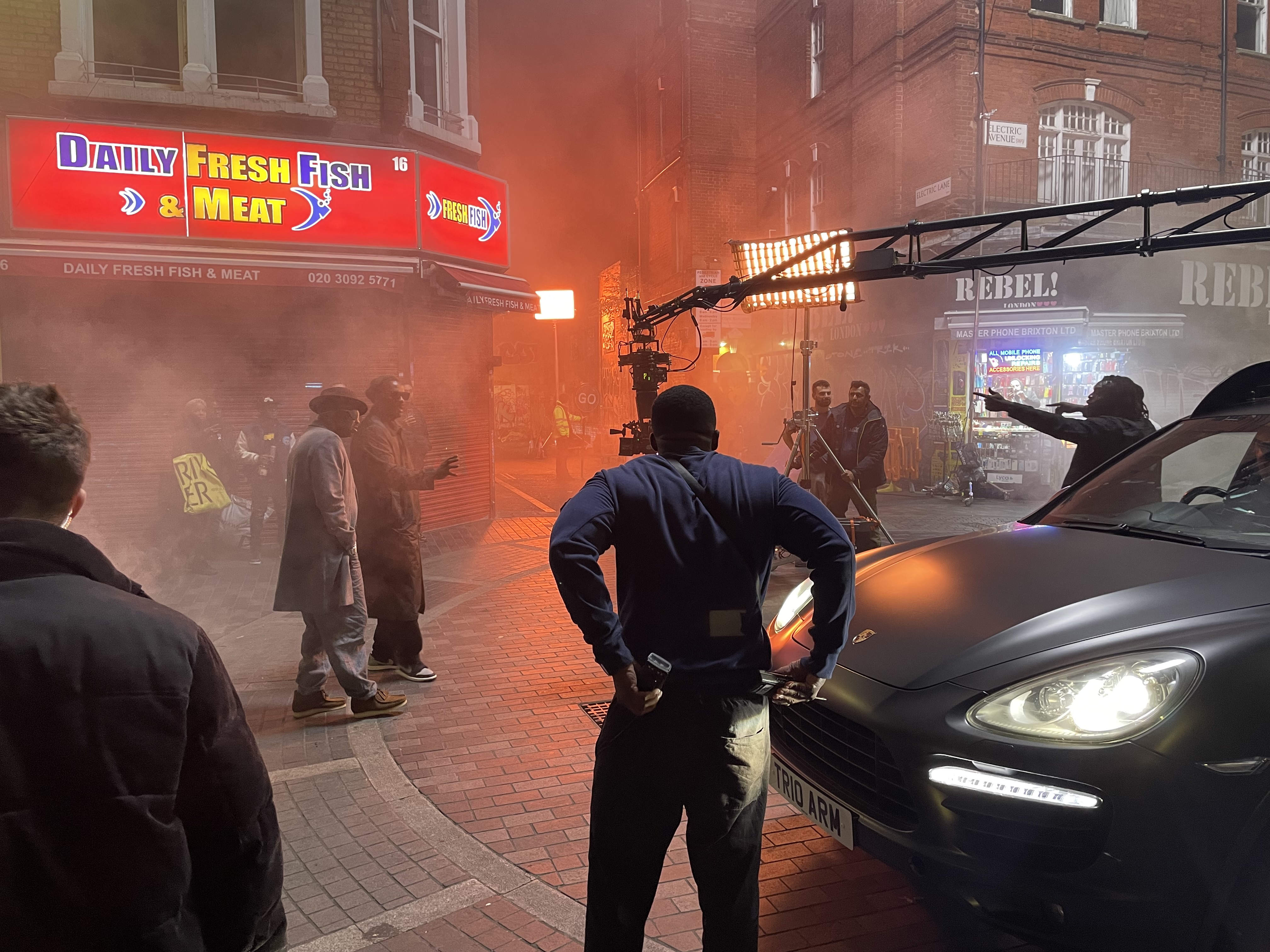 Music video set with crane and smoke along Electric Avenue Brixton. Slick Rick and Idris Elba rapping to camera