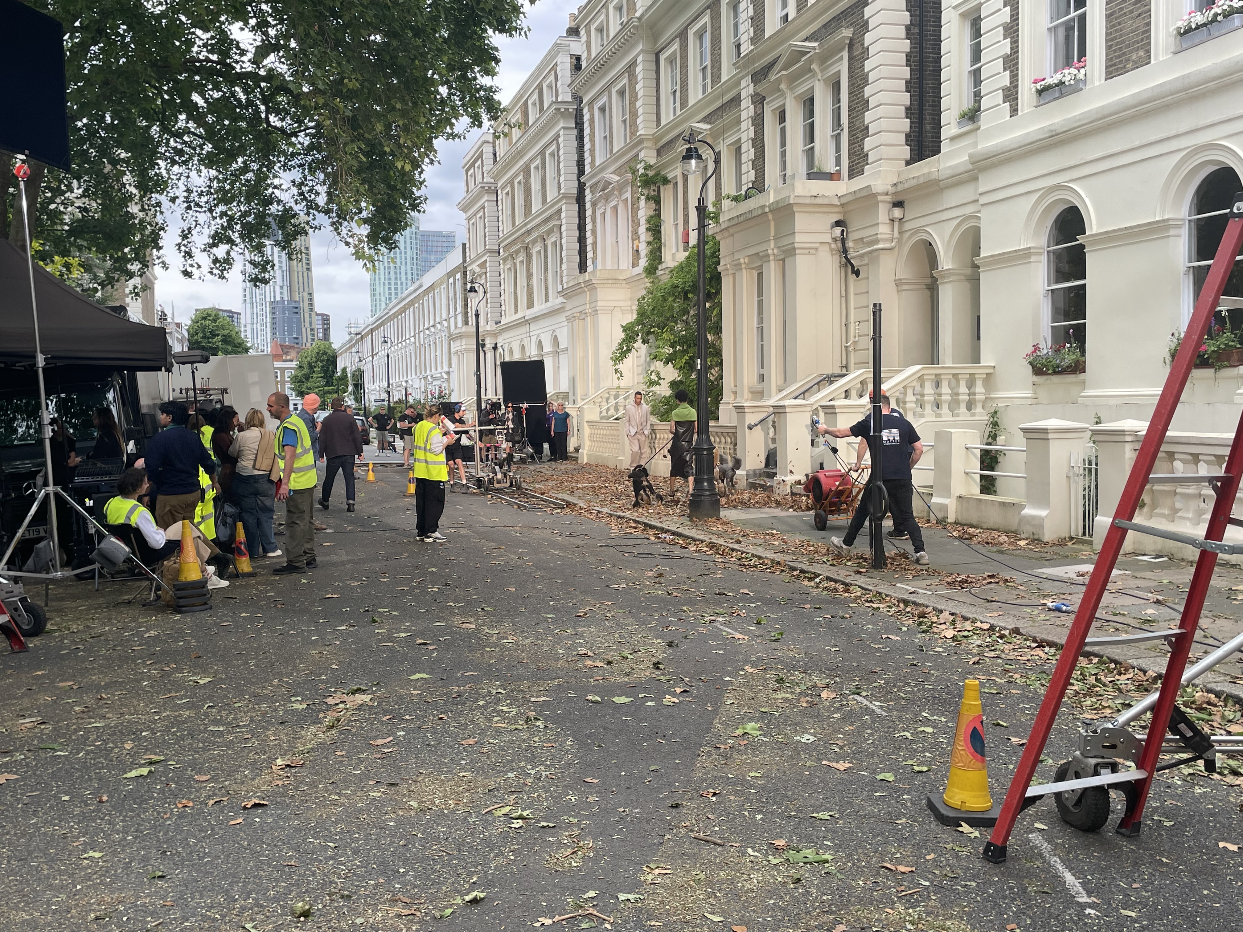 staff and crew in high vis shirts on Albert Square prepping the location for a Mark's and Spencer shoot.