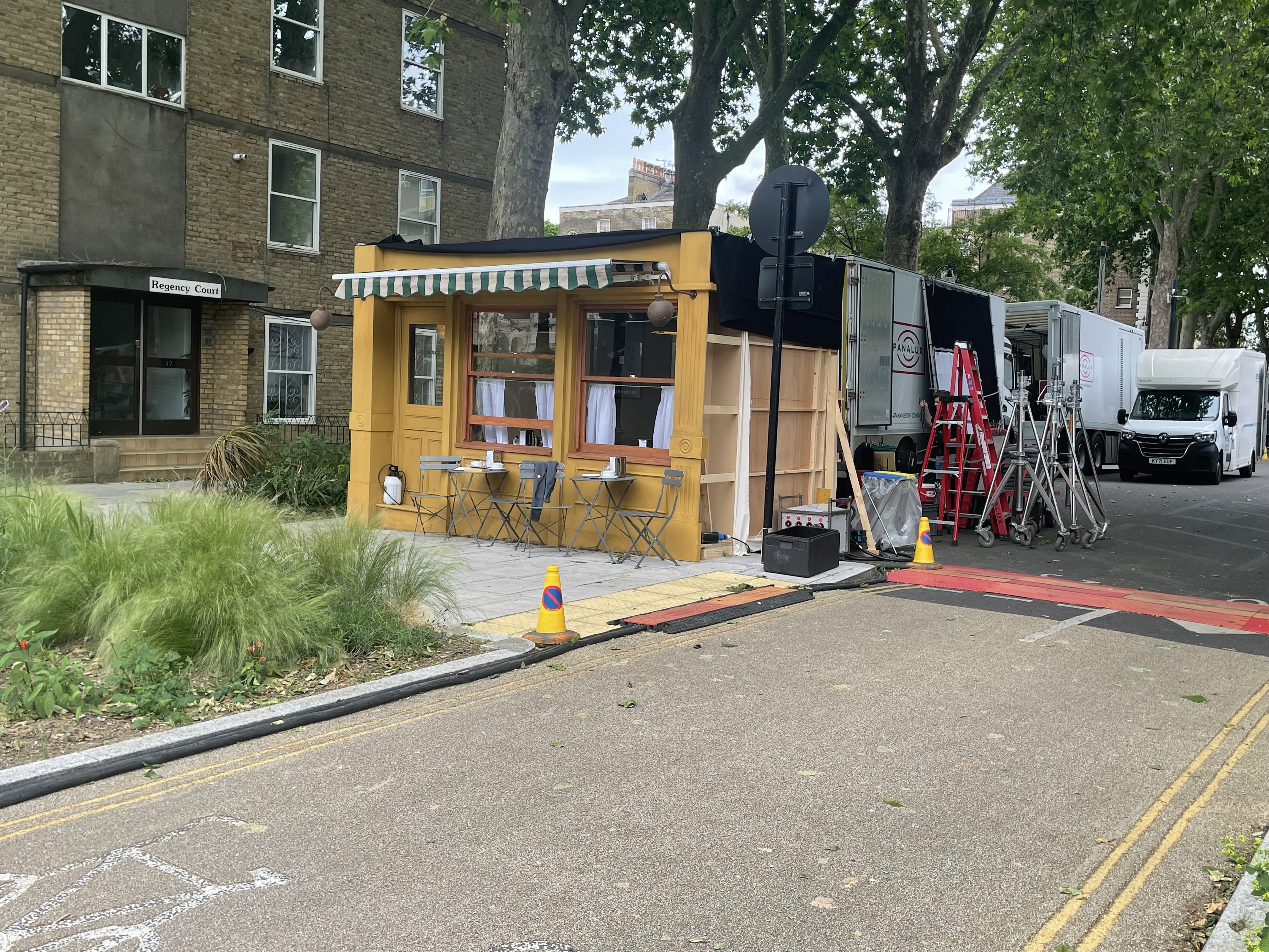 Prop caf with foldable chairs set outside. This is located on Albert Square.