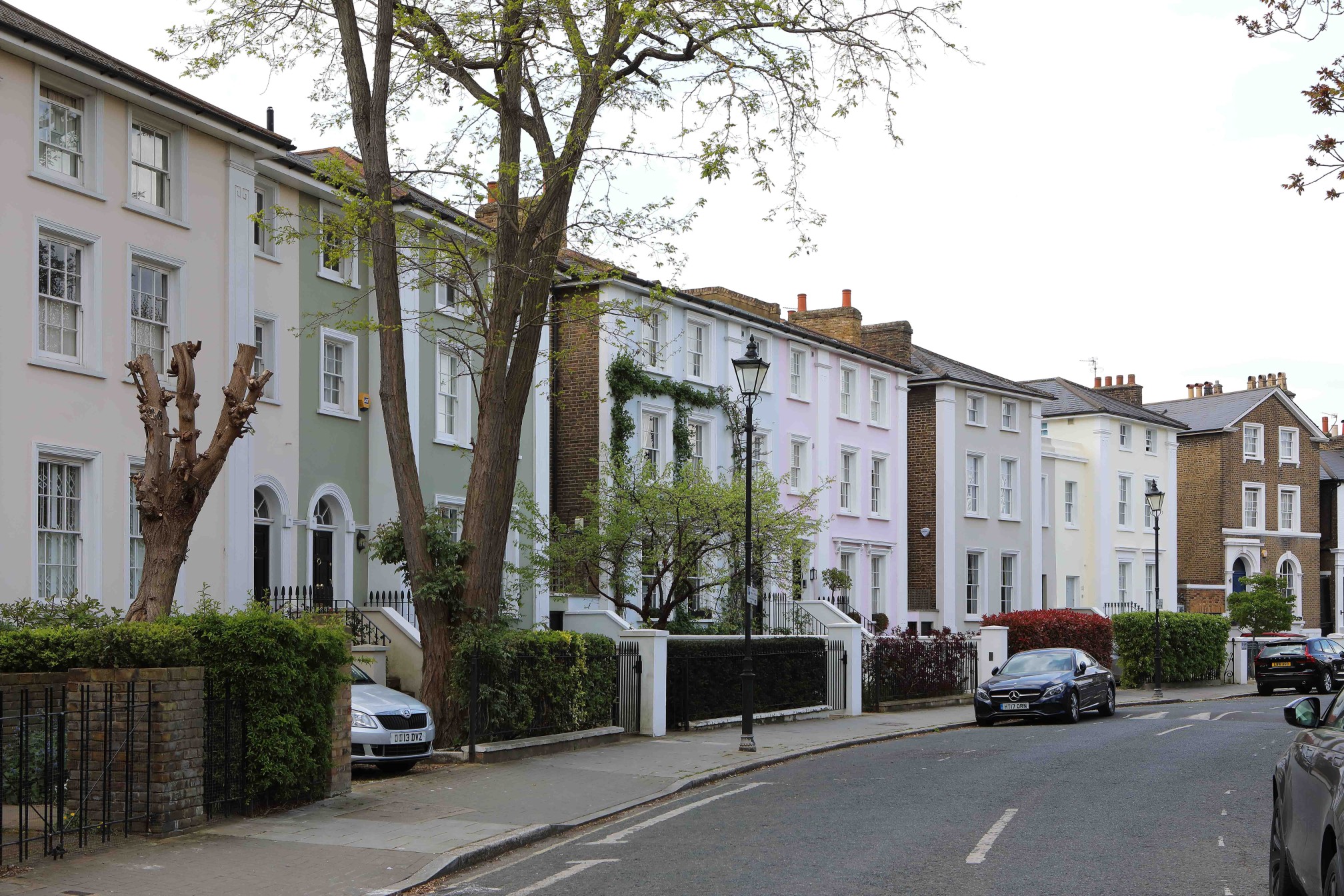 Street view of colorful terraced houses on Stockwell Park Crescent.