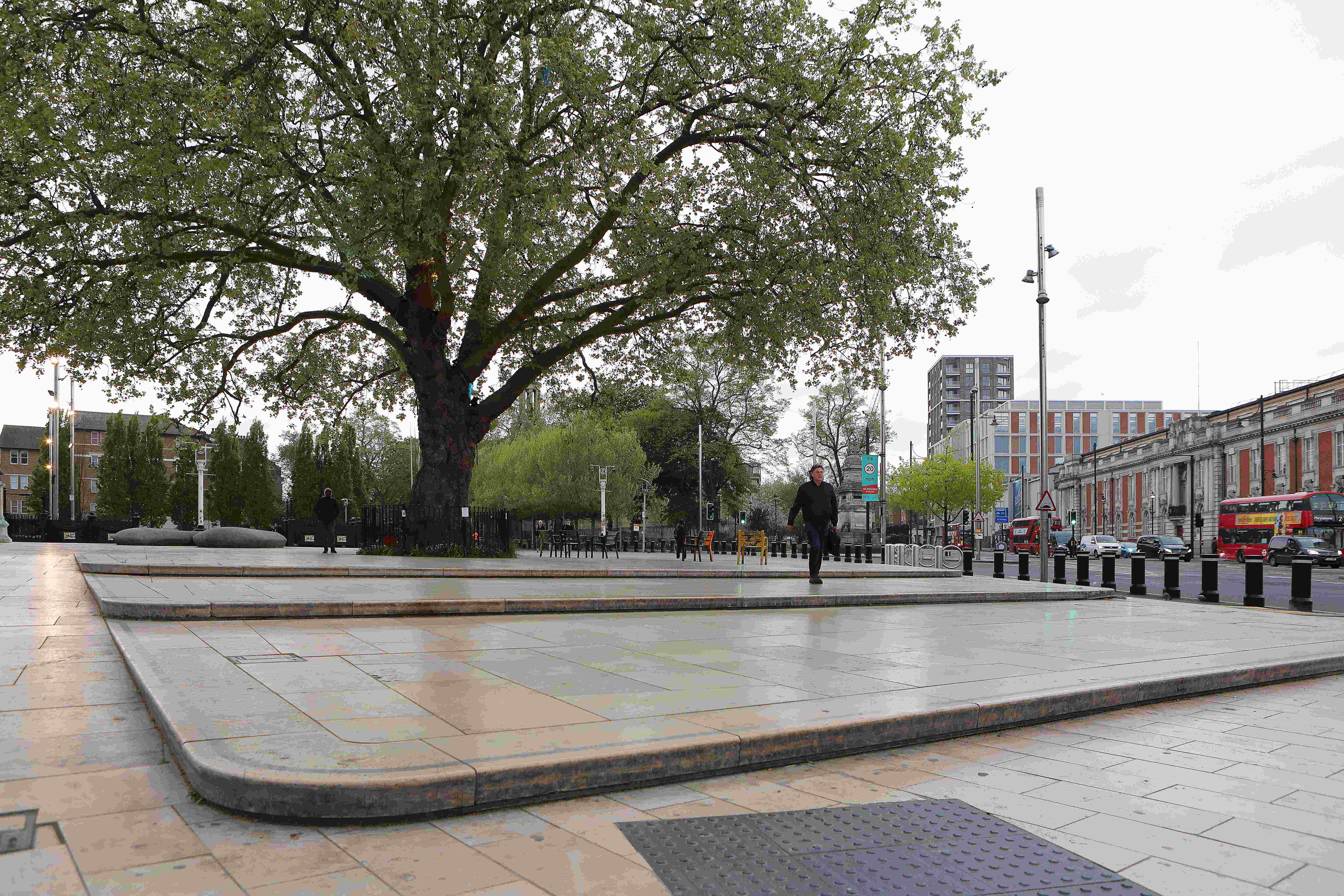 Windrush Square in Lambeth with a large tree and surrounding buildings.