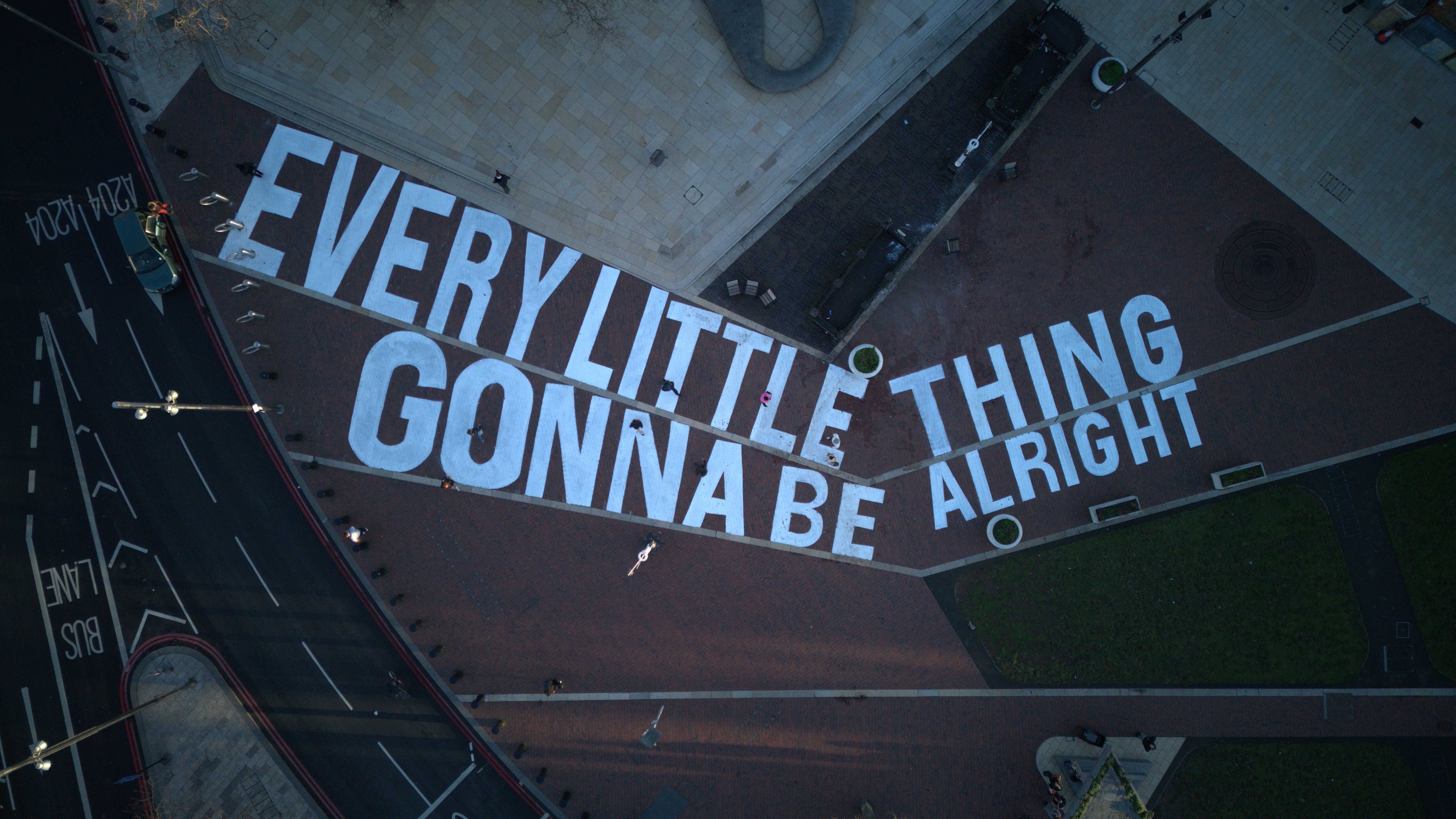 Large Bob Marley mural on the ground reading 'EVERY LITTLE THING GONNA BE ALRIGHT'.