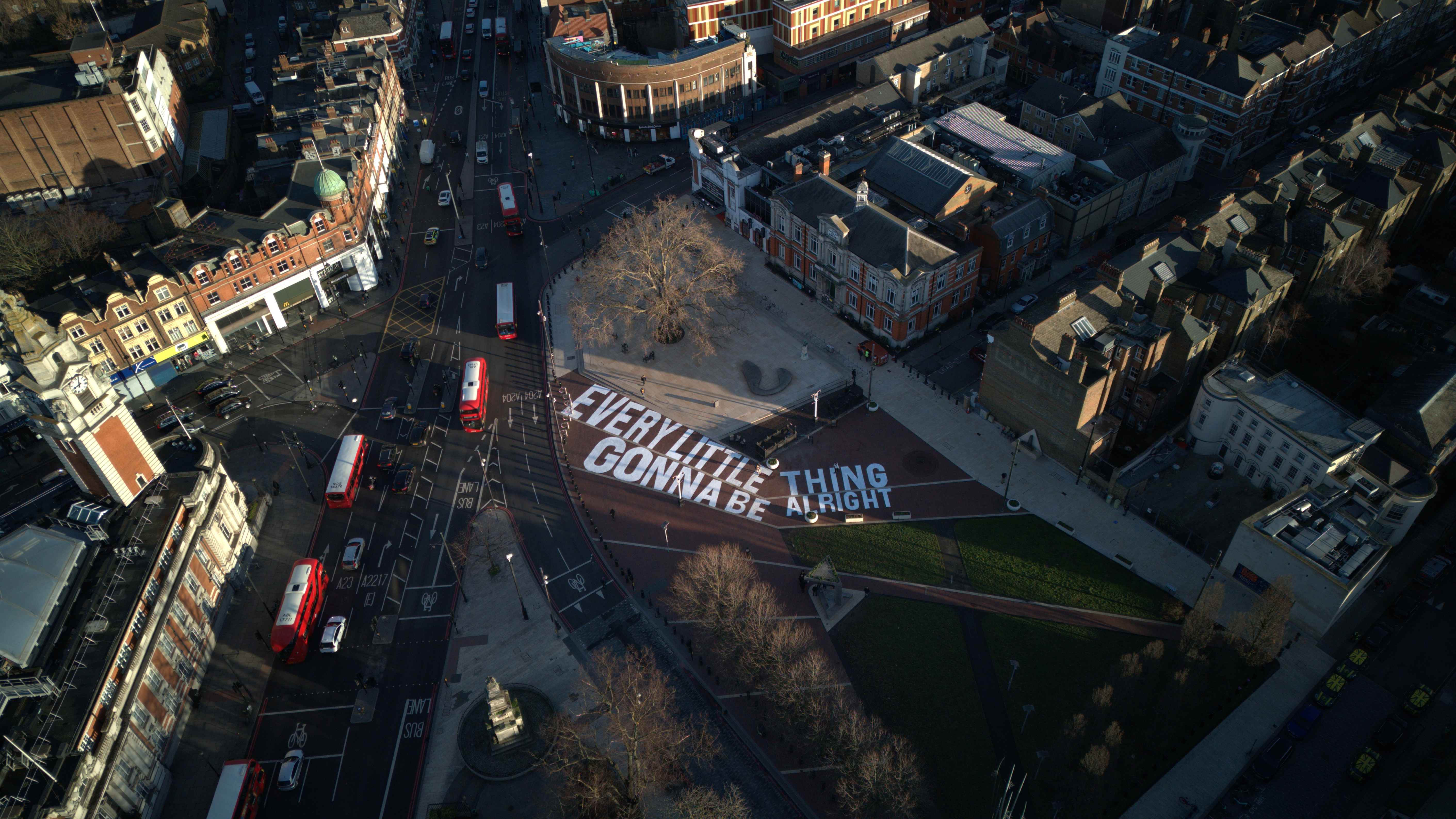 Aerial view of Windrush Square in Lambeth, displaying the message 'EVERY LITTLE THING GONNA BE ALRIGHT'.